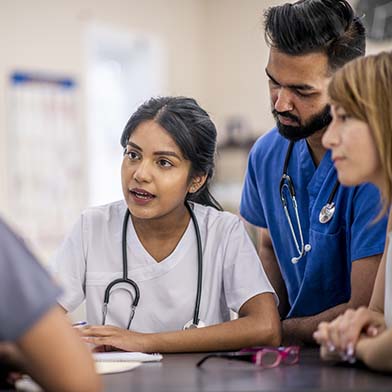 A medical professional explaining something to her team