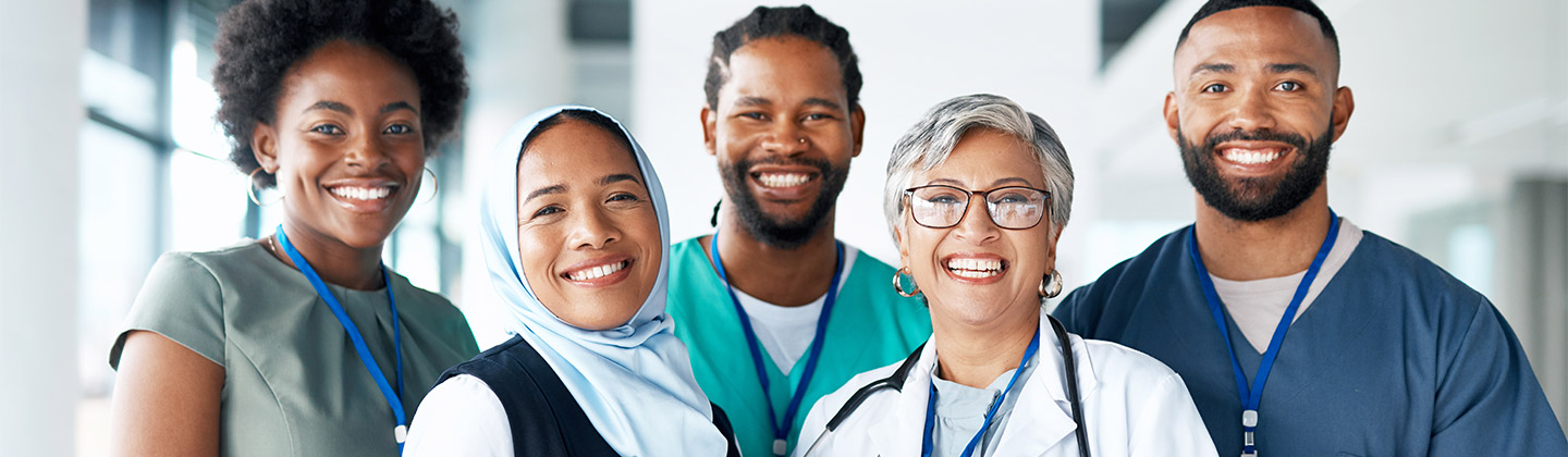 Group of smiling medical practitioners stand together