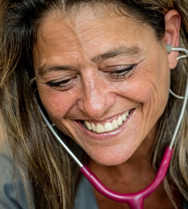 Nurse treating a patient and smiling