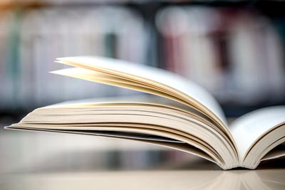 Open book on the table in the library